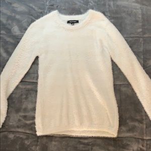 Light blue close to a white brand new sweater